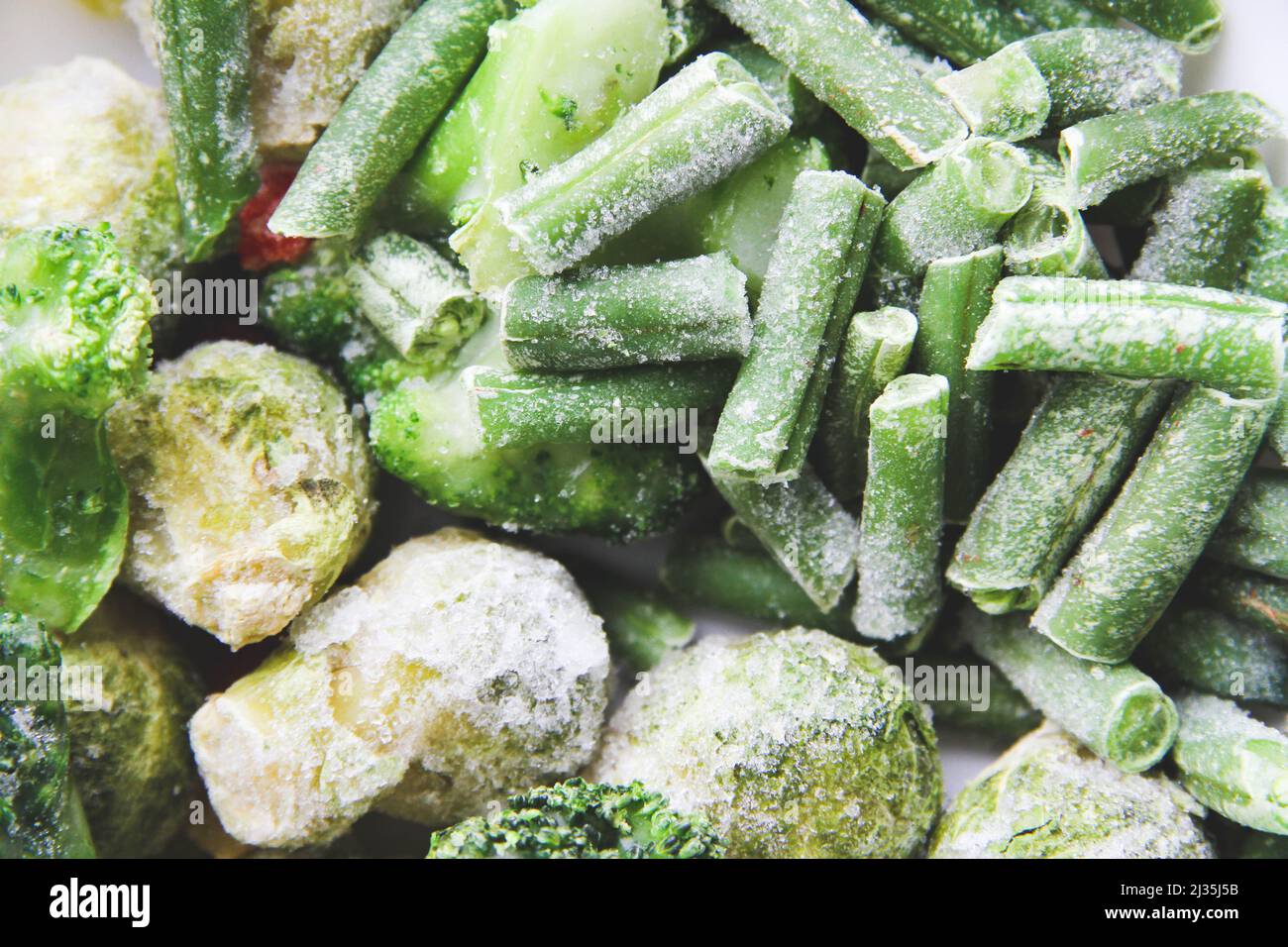 Frozen vegetables close up. Vegetables in the fridge. Ice on vegetables