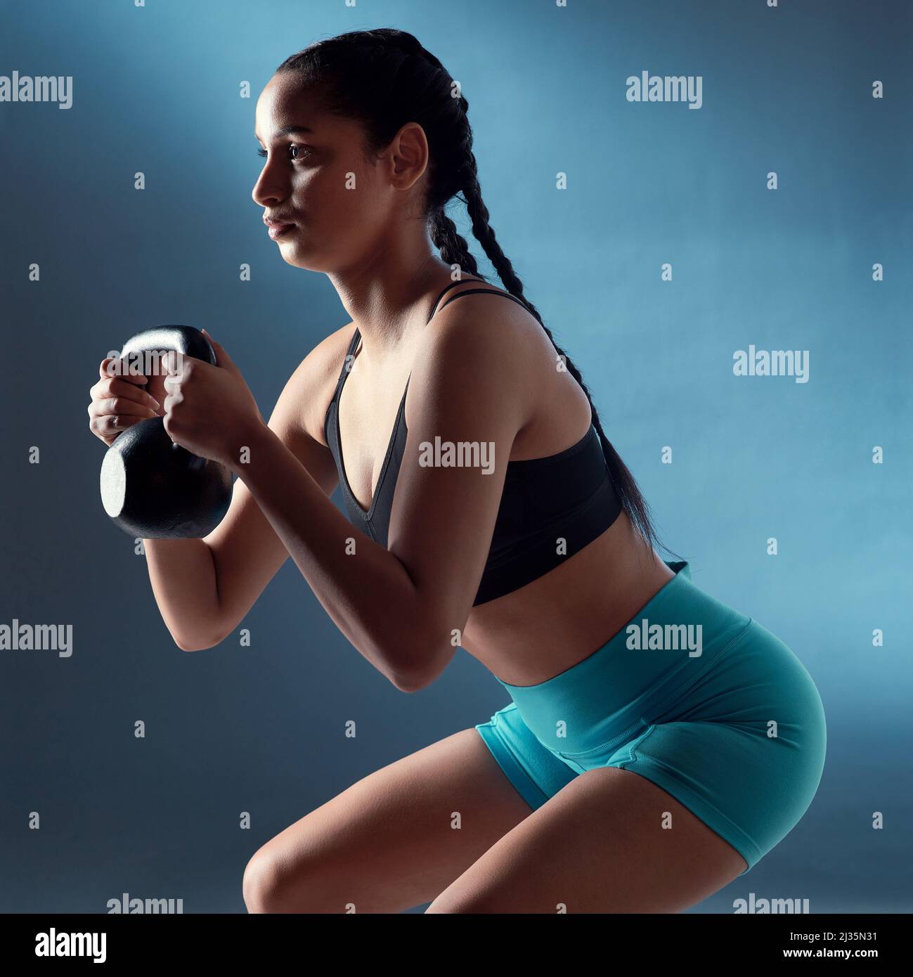 Doing sport. Young active fit woman with long legs listening to music and  doing sport Stock Photo - Alamy
