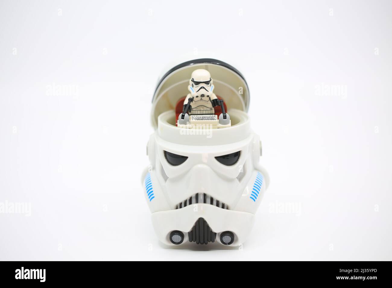 figurine open the head and sit inside it which also wear the similar helmet Stock Photo