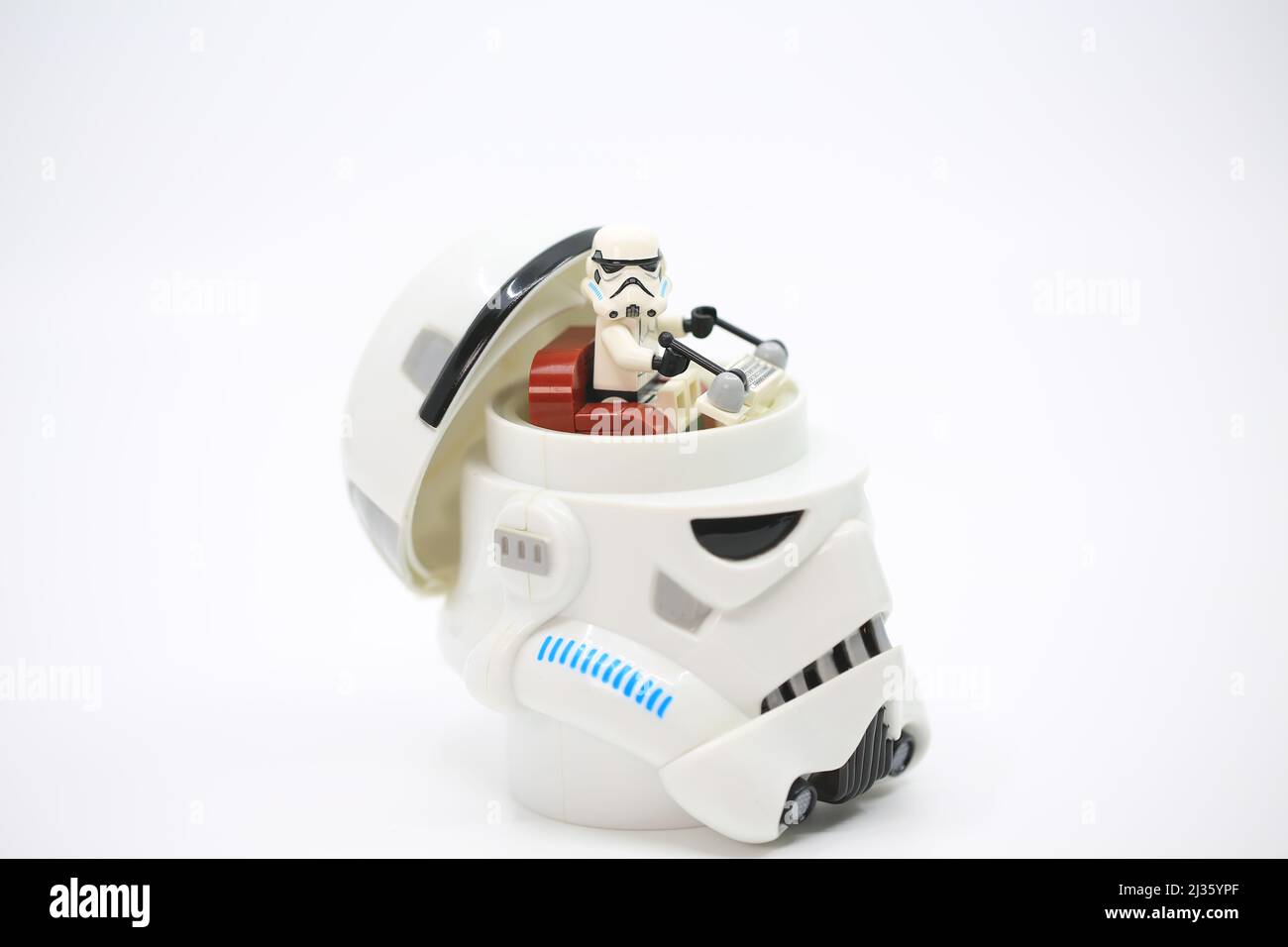 figurine open the head and sit inside it which also wear the similar helmet Stock Photo