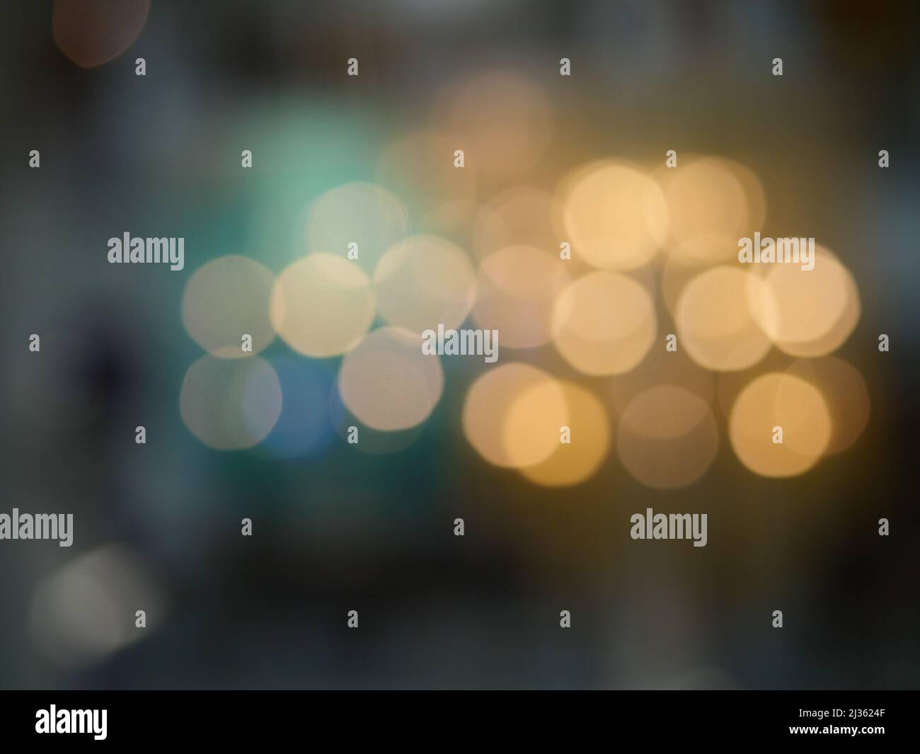 Bokeh from indoor lighting, Colorful light circles spread on blue with yellow and green background for the celebration of the holiday season Stock Photo