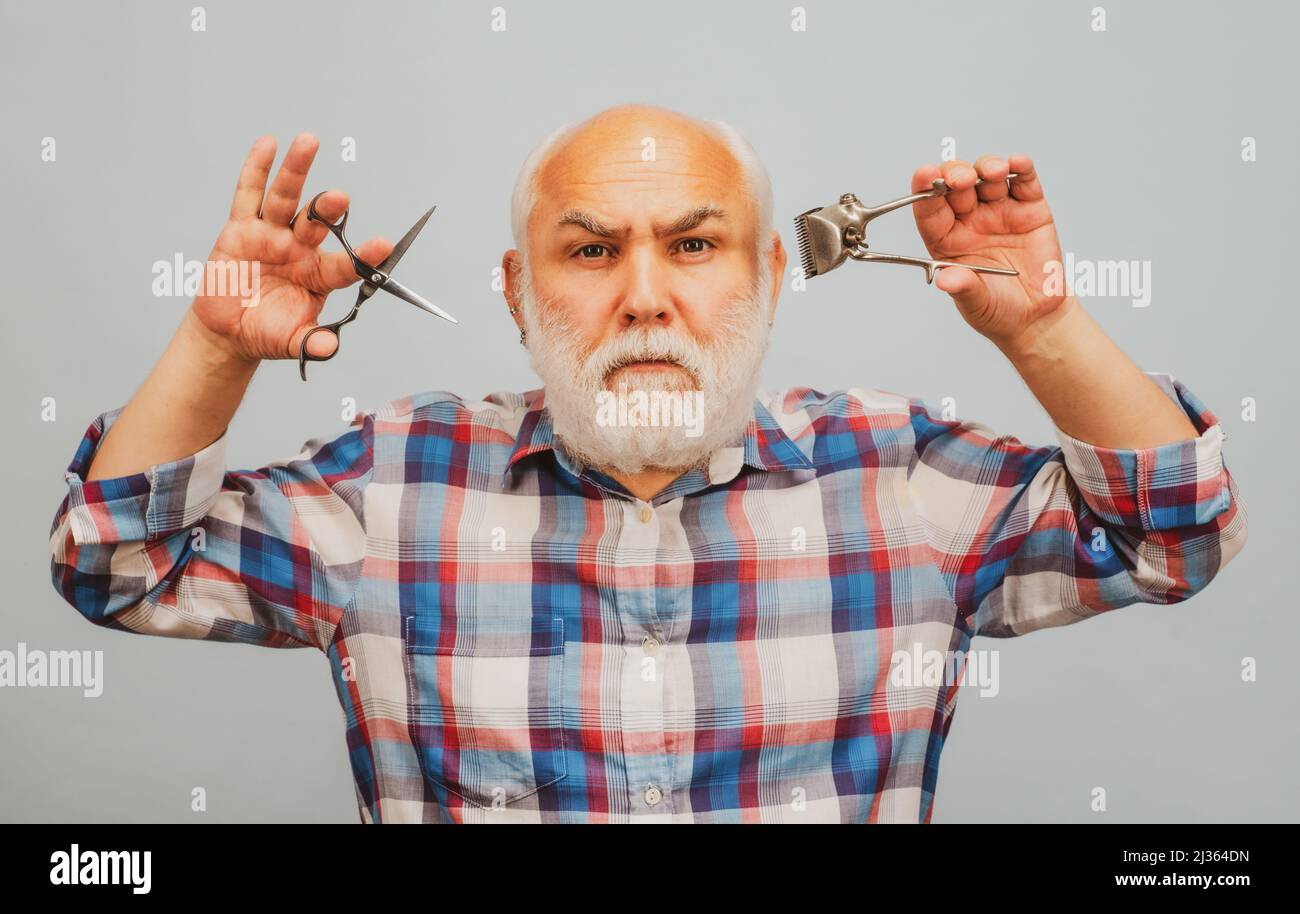 Middle aged barber man with barber scissors and hair clipper. Vintage