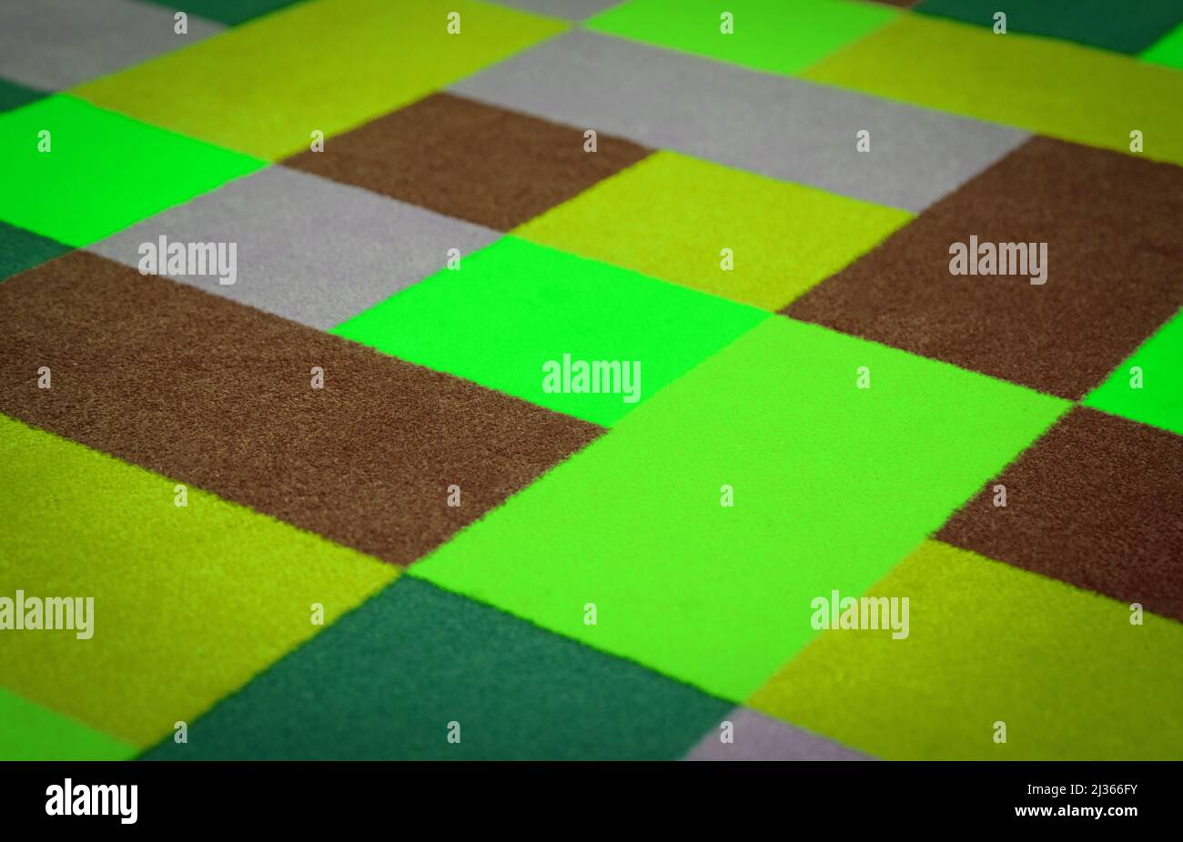 Bright colorful carpet on the floor, used and slightly dirty Stock