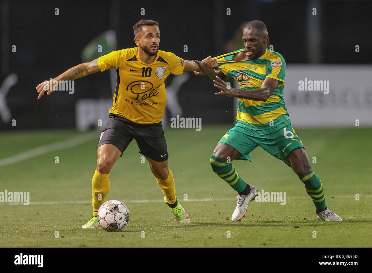 St. Petersburg, FL USA: The Villages SC midfielder Daniel Farias (10) tries to tackle and steal the ball by grabbing the shirt of Tampa Bay Rowdies mi Stock Photo