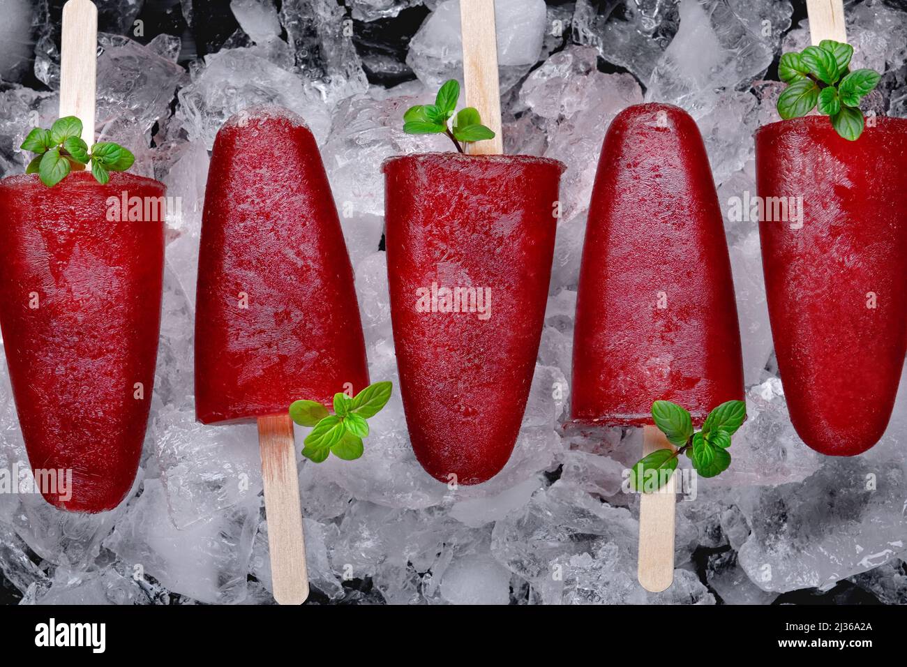 Fruit cherry ice lolly on ice Stock Photo Alamy