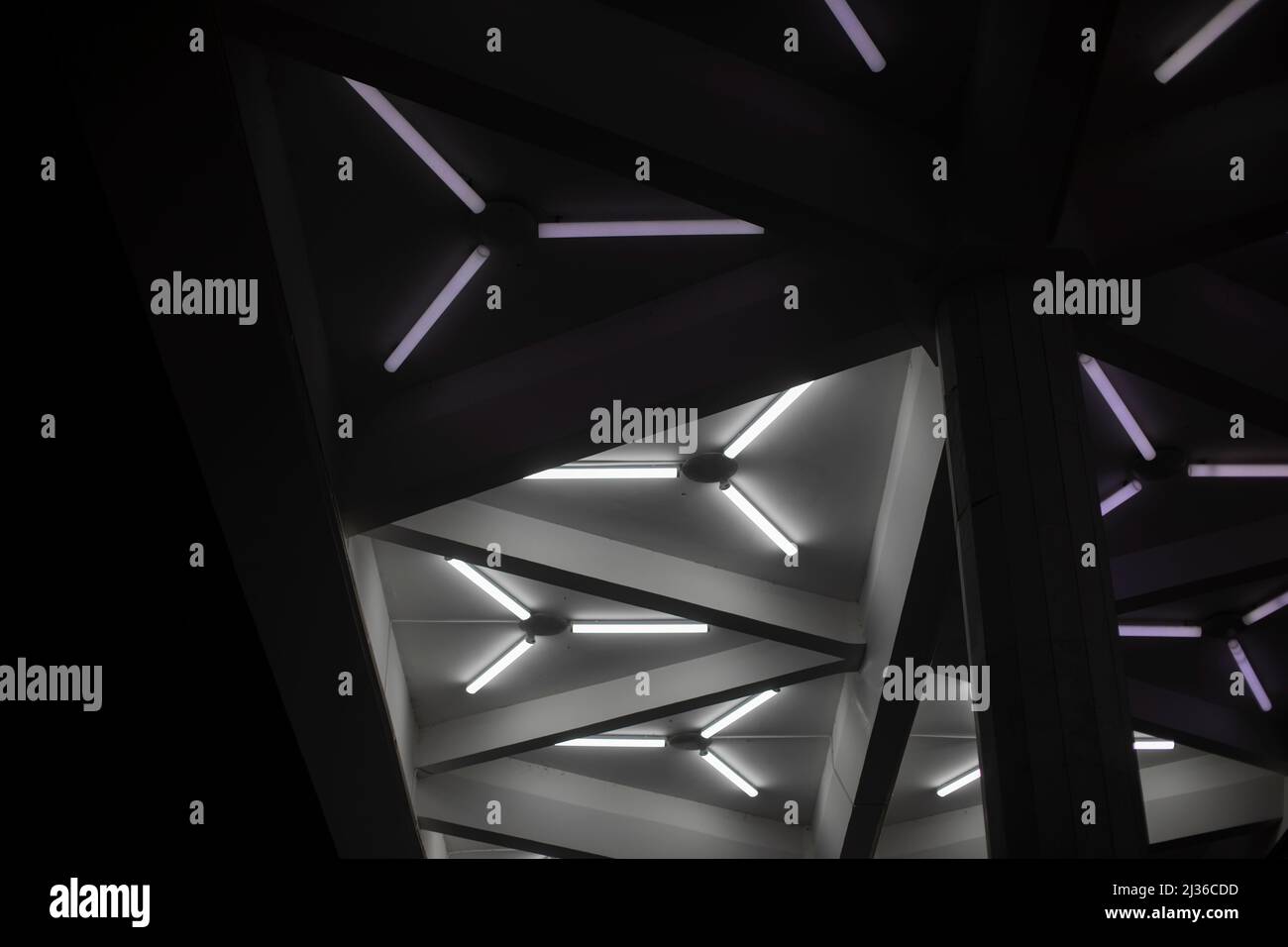 Light design. Fluorescent lamps on ceiling. Triangles of lamps