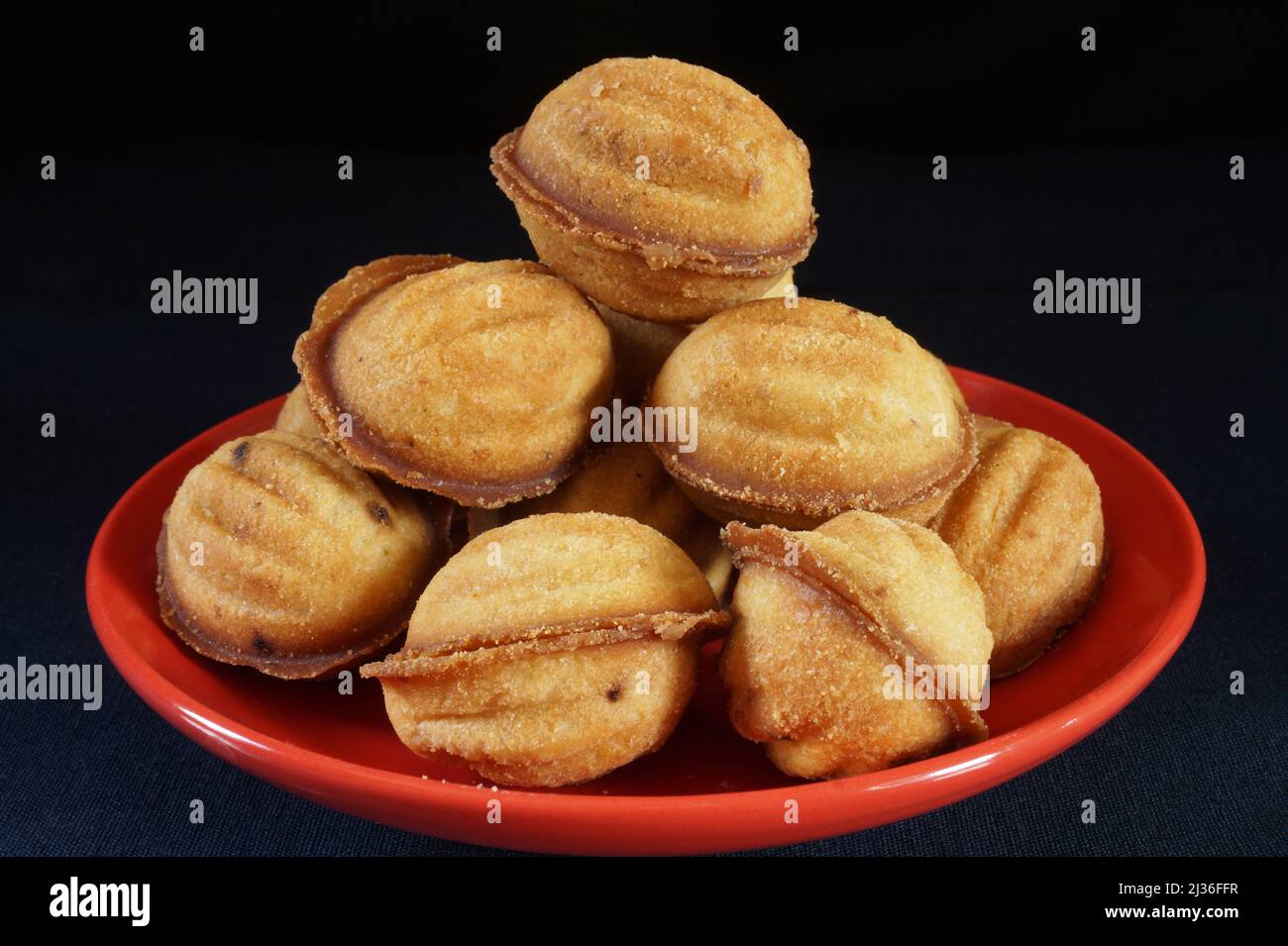 Pastry nuts with stuffing on the kitchen table, Food on a black background Stock Photo