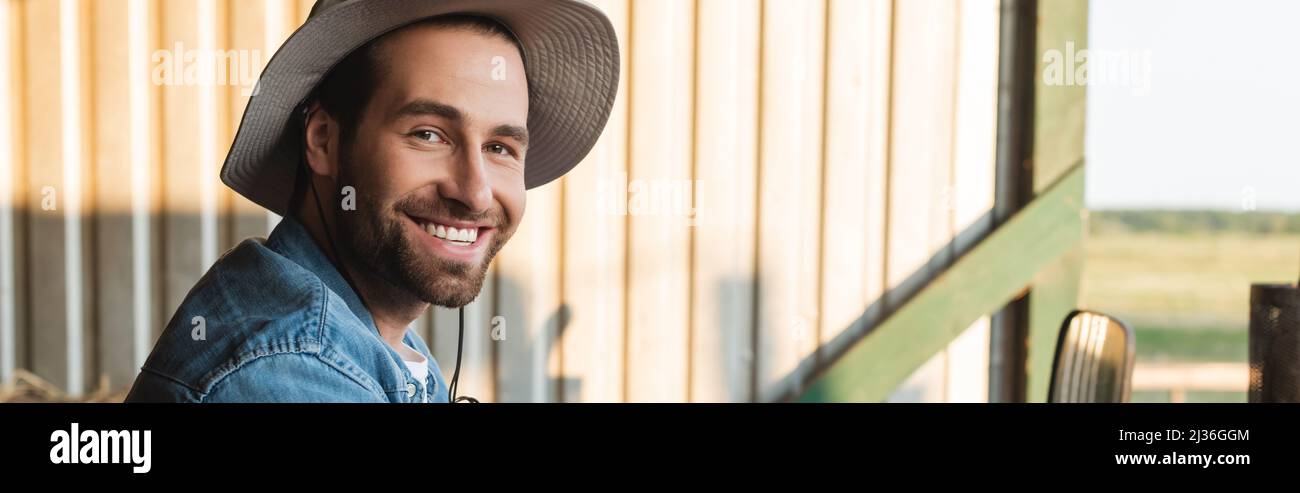 happy bearded farmer in brim hat smiling at camera, banner Stock Photo