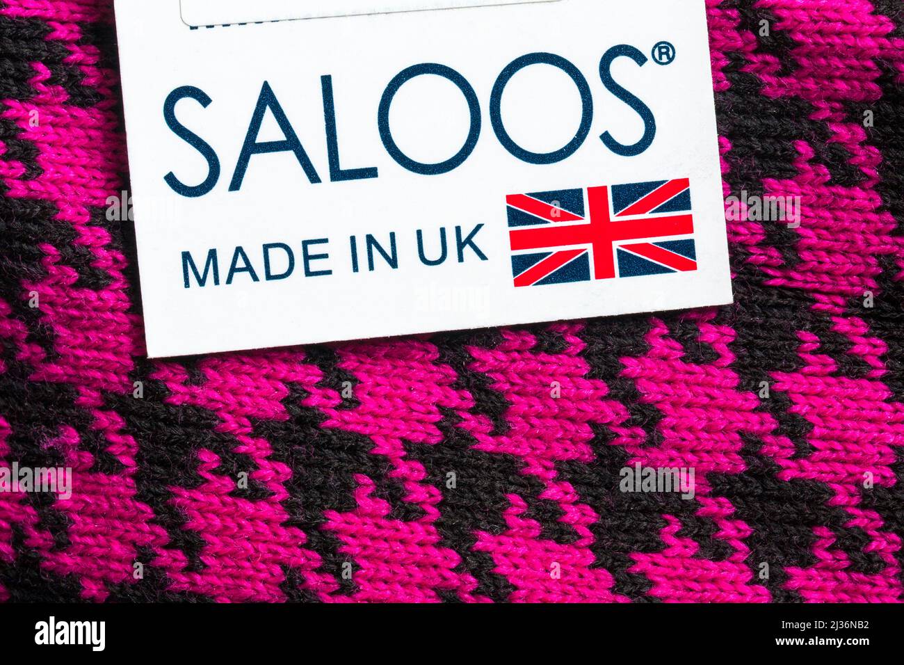 Saloos Made in UK label tag on pink and black jumper clothing garment Stock Photo