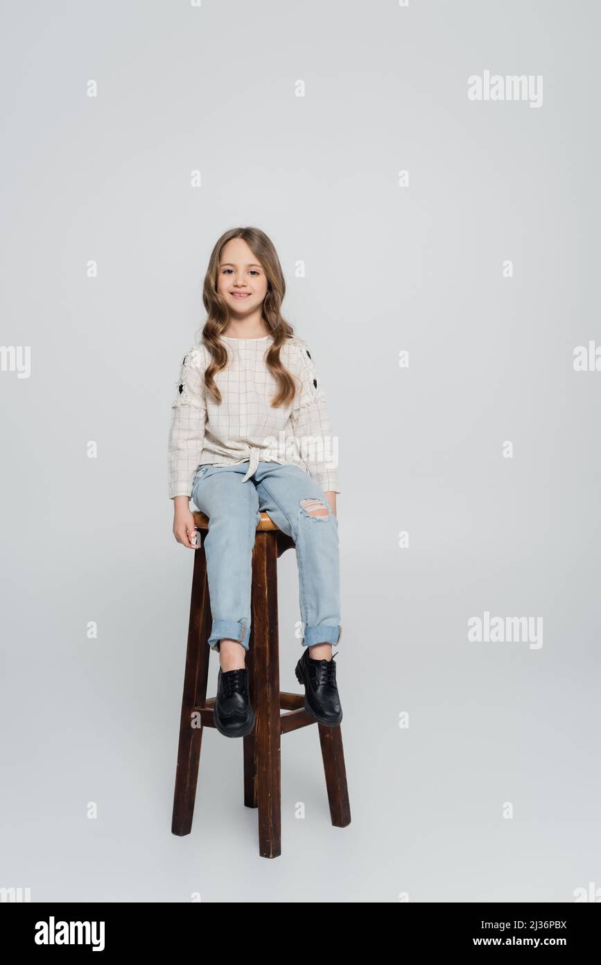Girl sitting on stool hi-res stock photography and images - Alamy