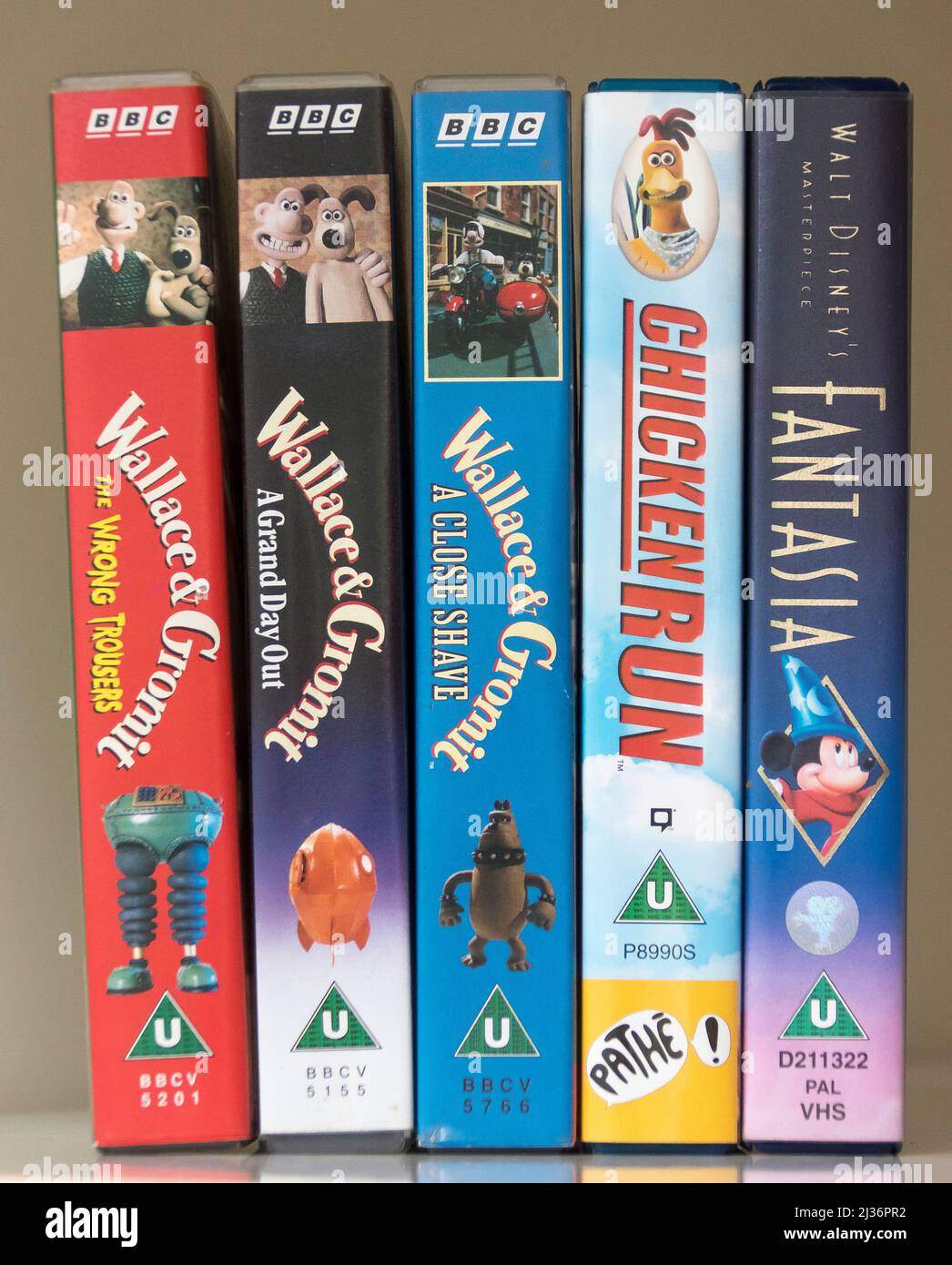 Five VHS video cassetes of childrens' favourites from about 1993. Three of  Wallace and Gromit, Chicken Run and Fantasia. British format. Stock Photo