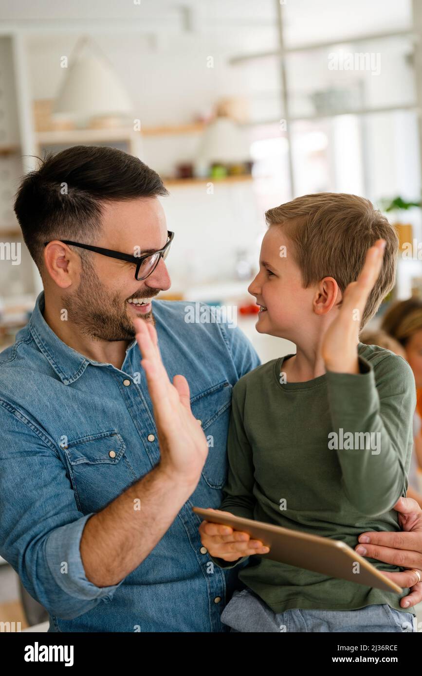 Home schooling social distance e-learning online education concept. Happy boy using tablet at home. Stock Photo