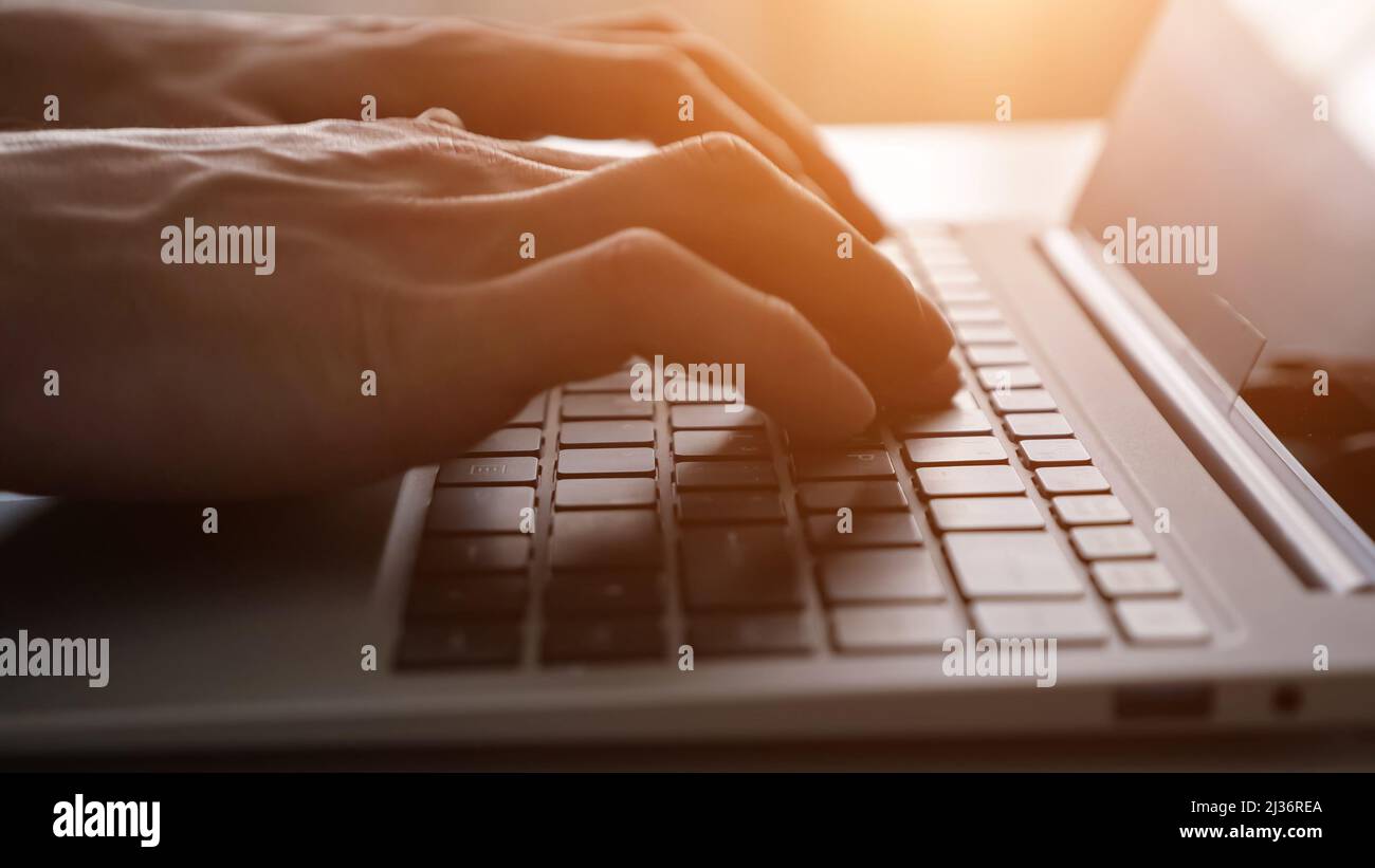 Man freelancer opens laptop to continue working on project Stock Photo