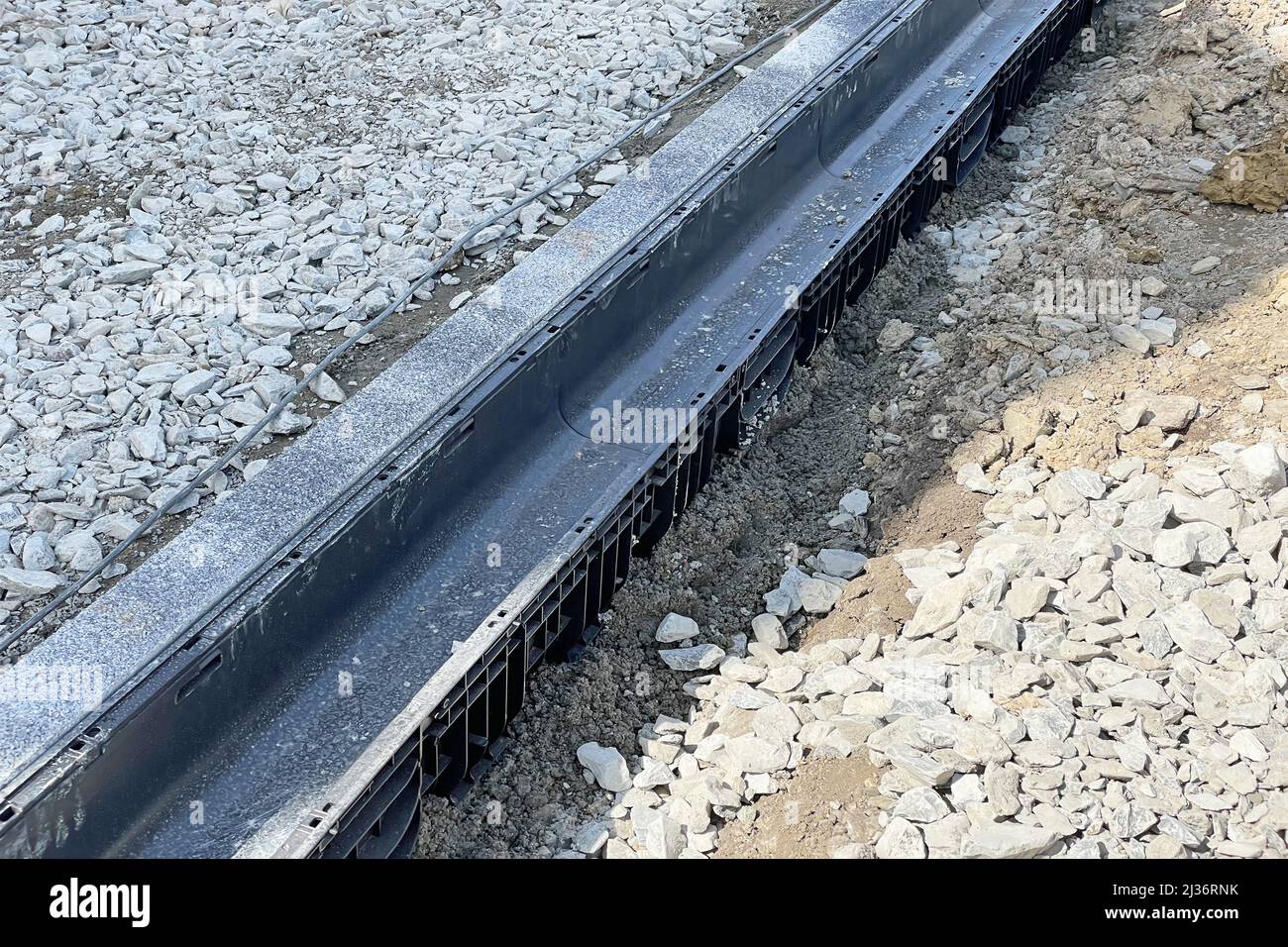 Installation and construction of laying a gutter to collect and drain rainwater. Territory improvement. Stock Photo