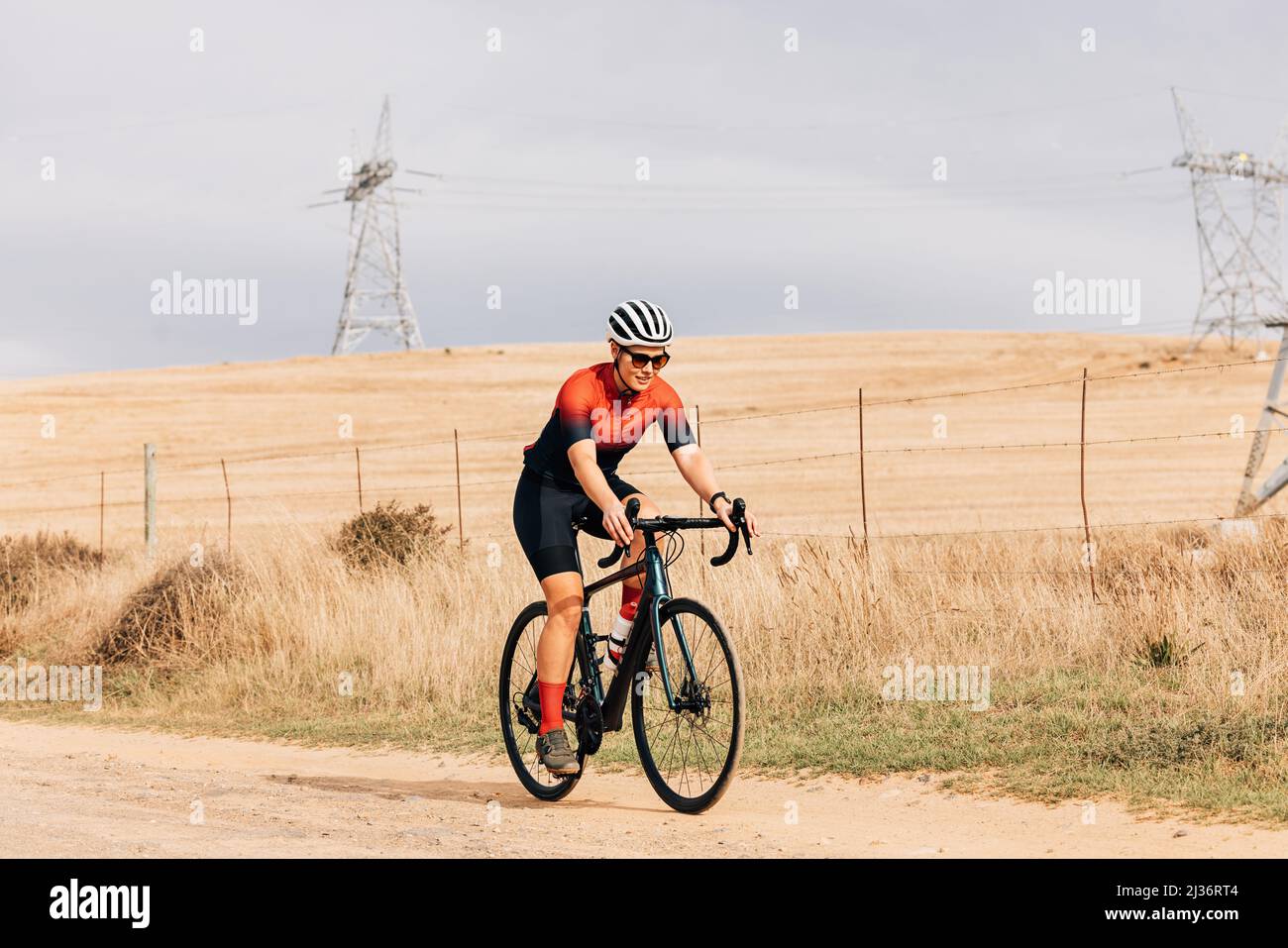 Professional athlete cycling on countryside. Cyclist riding bike. Stock Photo