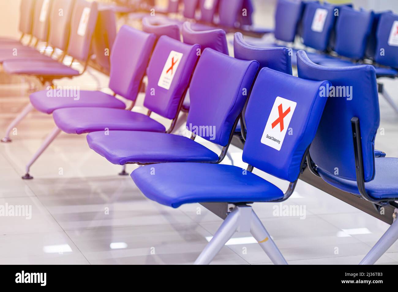 Bench chair in waiting area with keep distance space from seat social distancing. Stock Photo