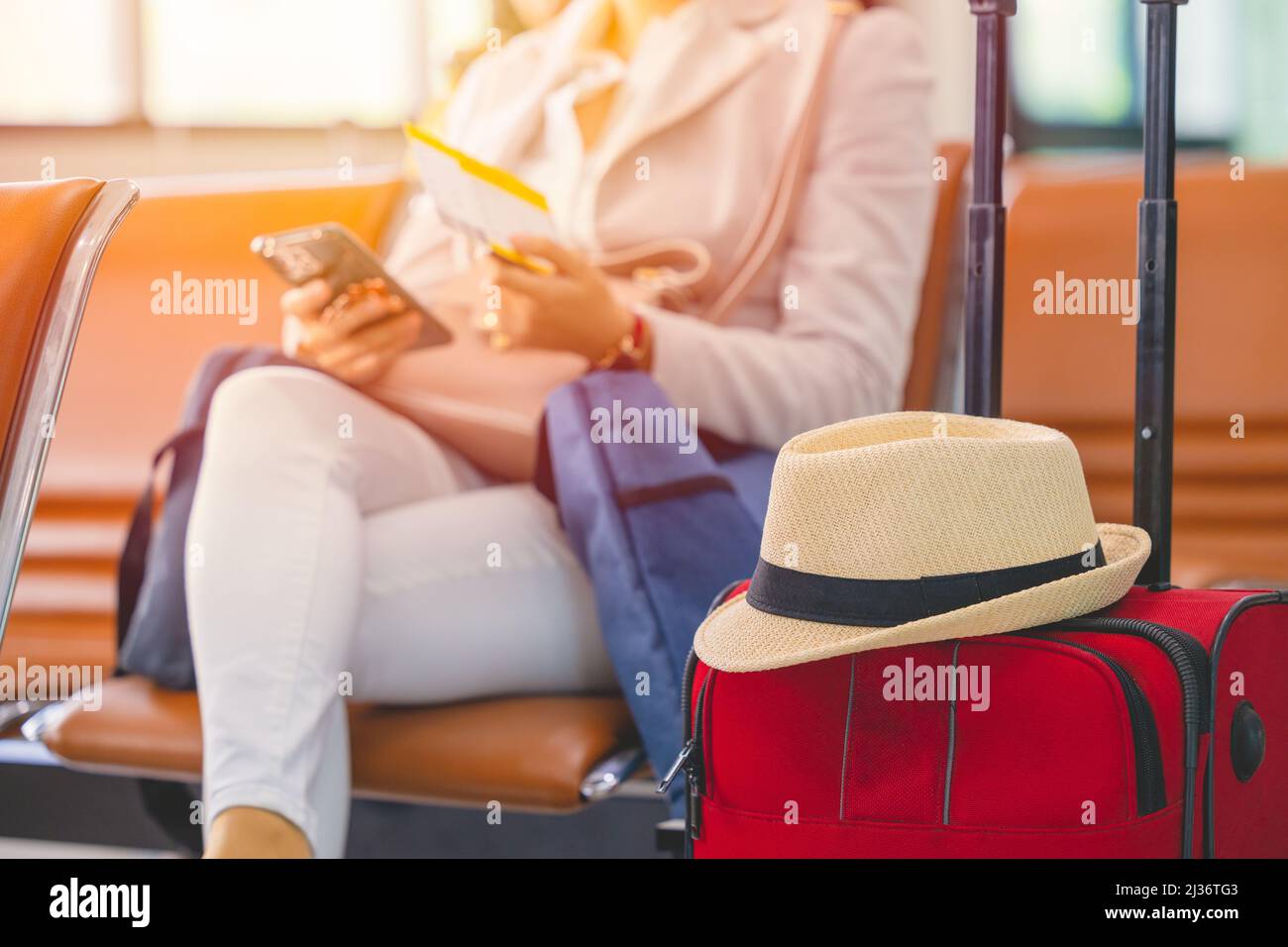Single woman Travel luggage and ticket waiting for vacation flight in airport. Stock Photo