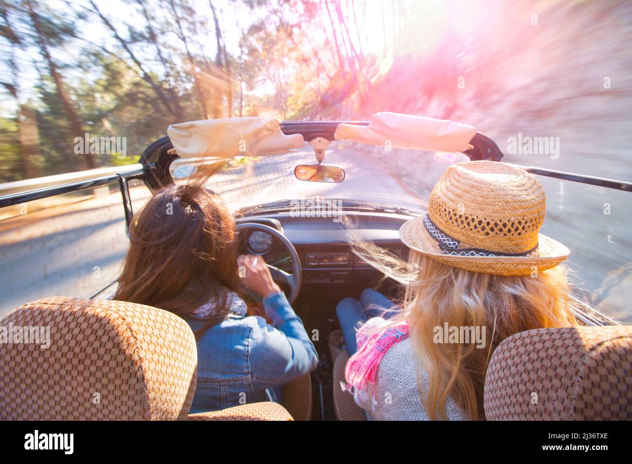 Female friends take a road trip in a classic VW Beetle Stock Photo