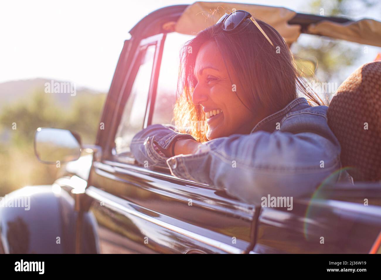 Asian woman in her classic VW Beetle Stock Photo