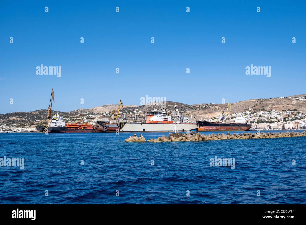 Neorion shipyard harbour and industrial plant at Ermoupolis Syros island, Cyclades, Greece. Ship, crane, international trade, shipping, container, car Stock Photo