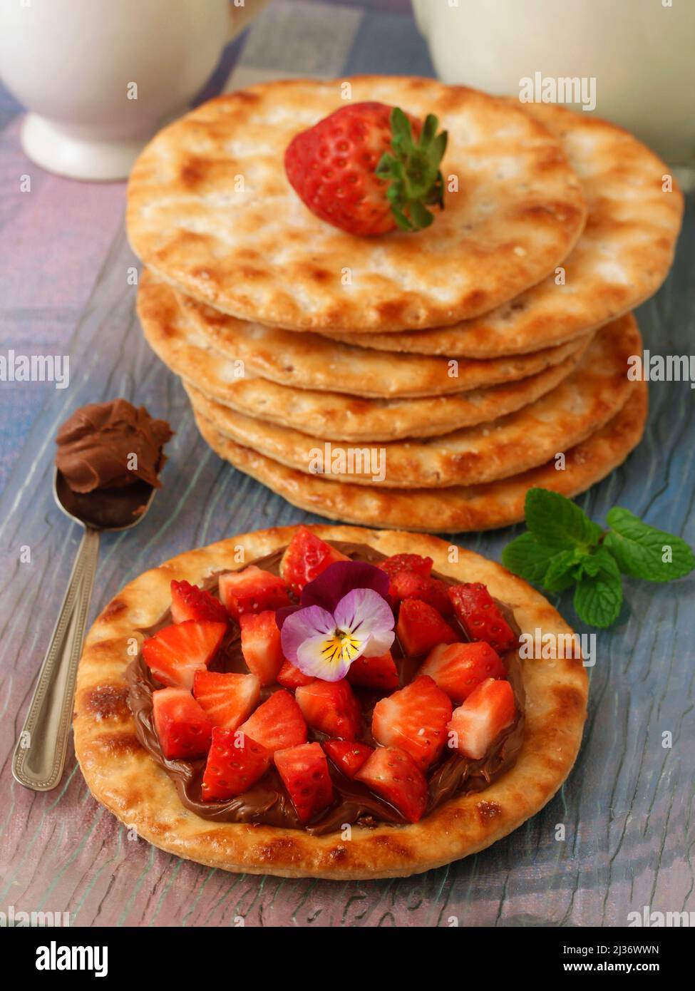 Cakes with chocolate and strawberries. Tortas de aceite, typical spanish cakes. Stock Photo