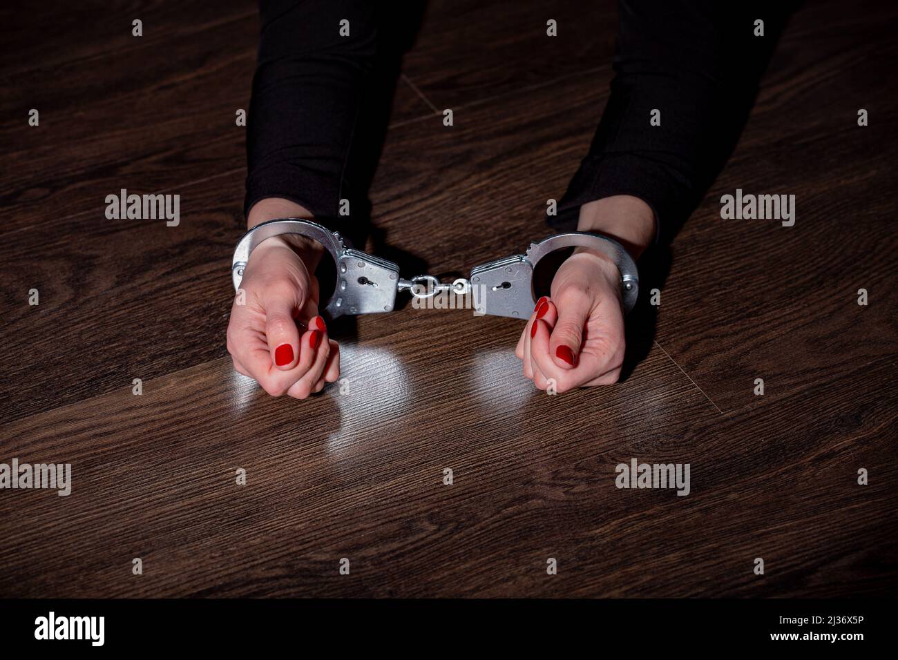 women's hands in handcuffs Stock Photo