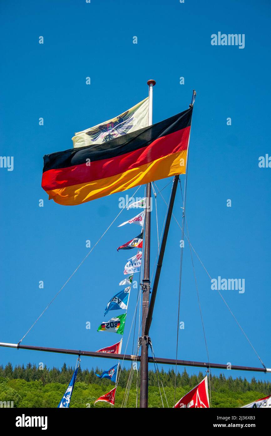 Neckargemuend, Germany: May 12, 2008: German flag at traditional Schiffermast Transation: skipper's mast in Germany decorated with many flags. Stock Photo