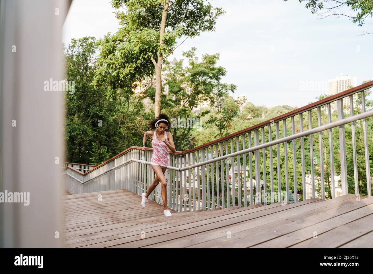 Black woman running up stairs hi-res stock photography and images - Alamy