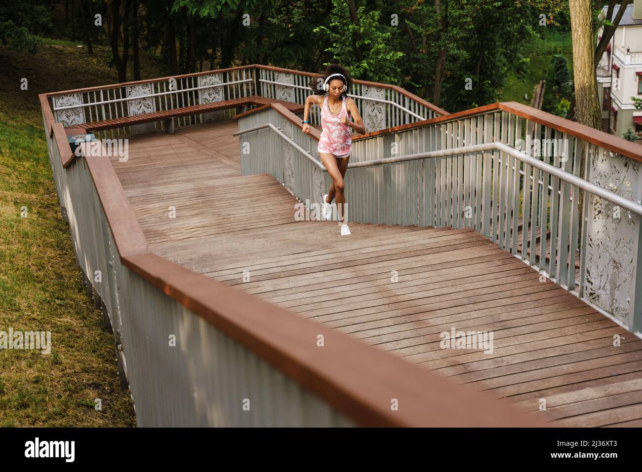 Black woman running up stairs hi-res stock photography and images - Alamy