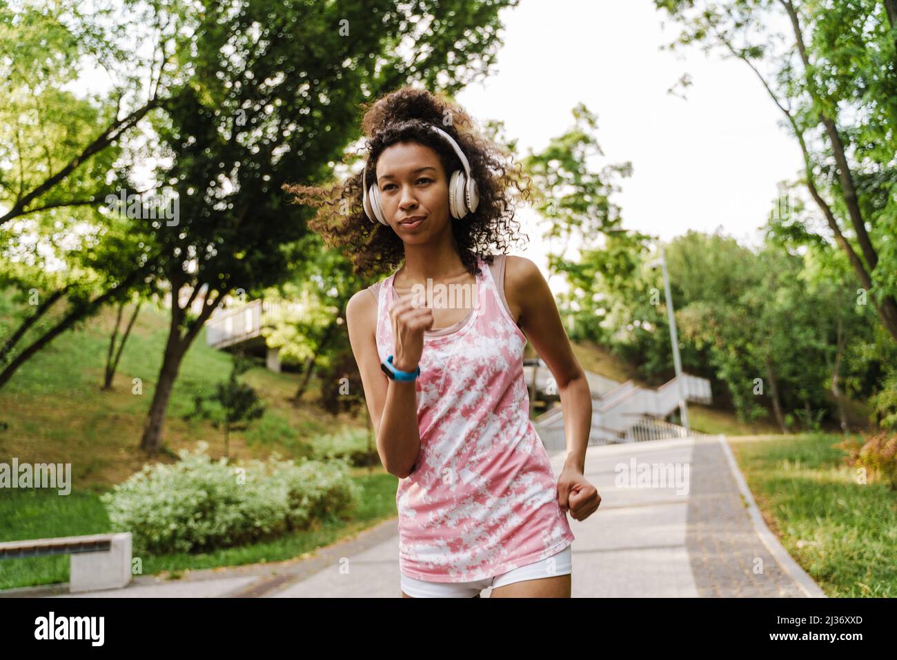 Black woman running headphones hi-res stock photography and images - Alamy