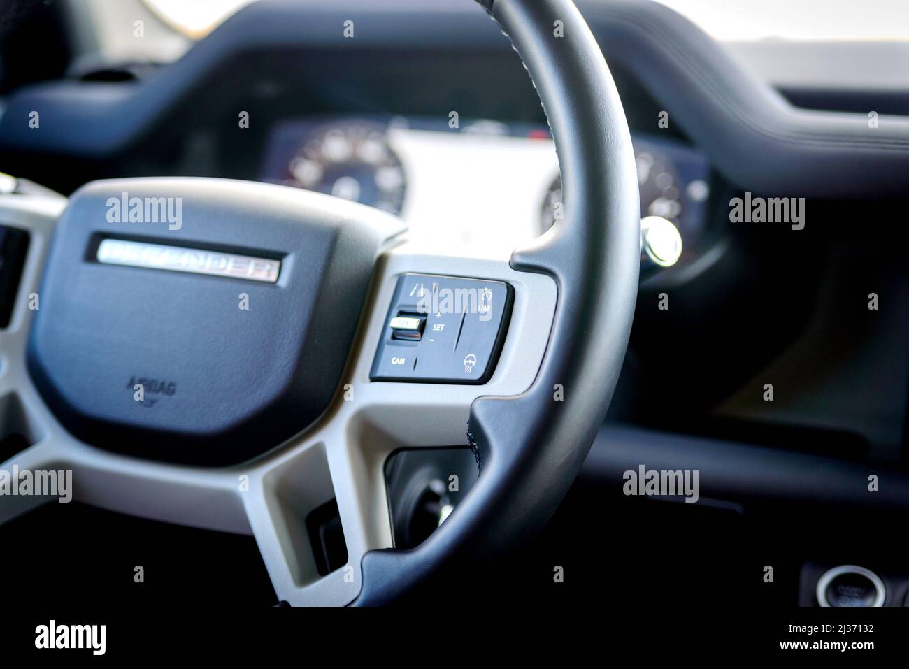 Russia, Rostovskaya oblast, 2021 June 09: Cruise control switches on steering wheel of New Land Rover Defender is a four-wheel drive off-road SUV. Stock Photo