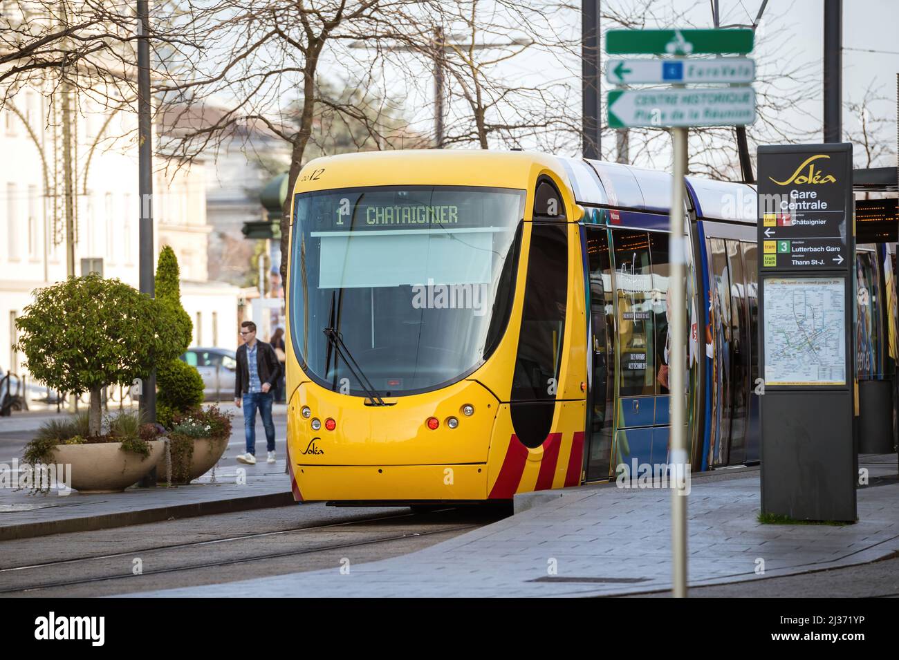 Mulhouse, France - Dec 19, 2015: Front view of 1 Chataignier yellow Tramway de Mulhouse public transportation at the station Gare Centrale - Central Railroad station Stock Photo