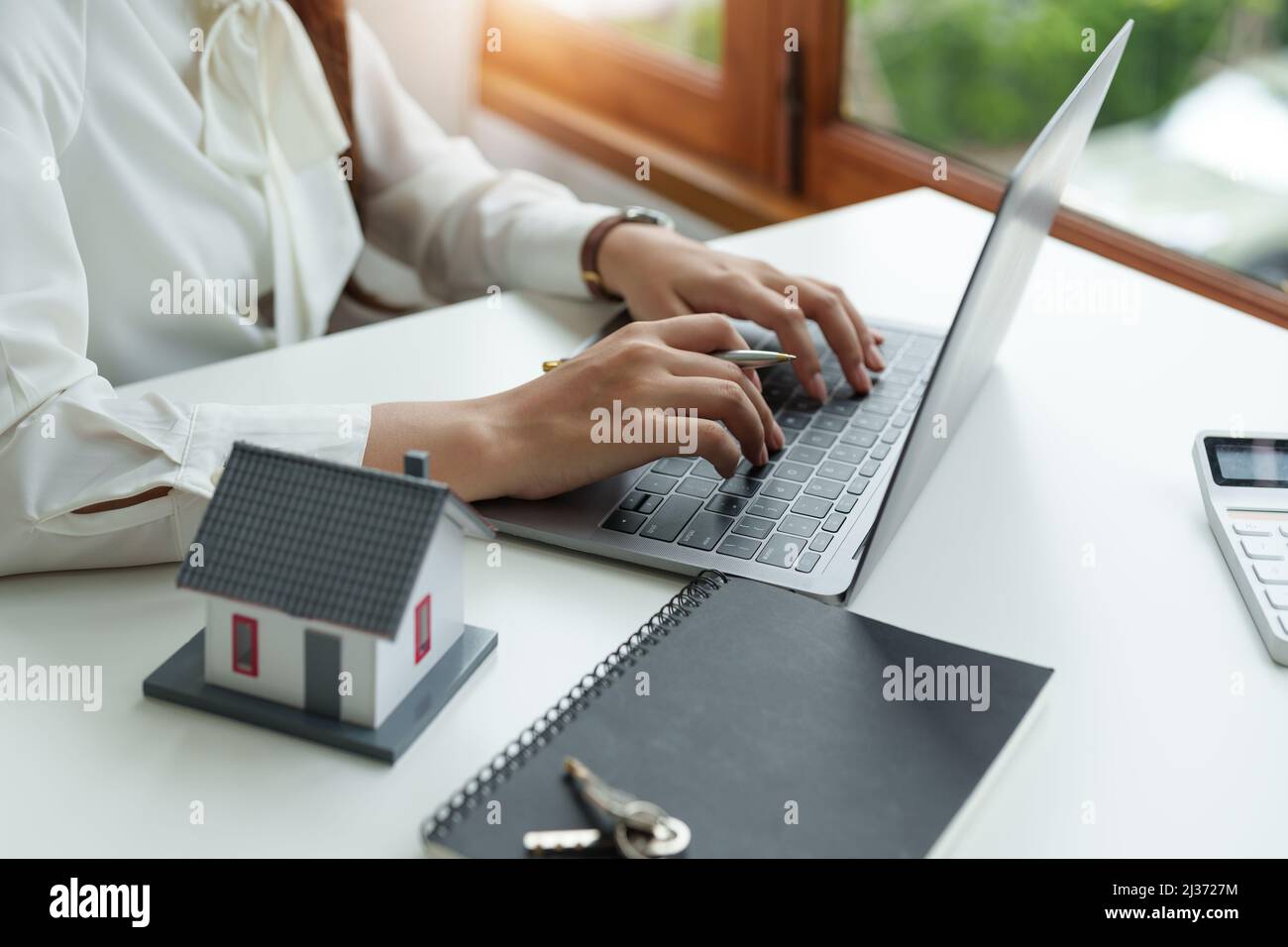 Real estate value and cost using laptop computer concept. Technology, mortgage, rent and buy