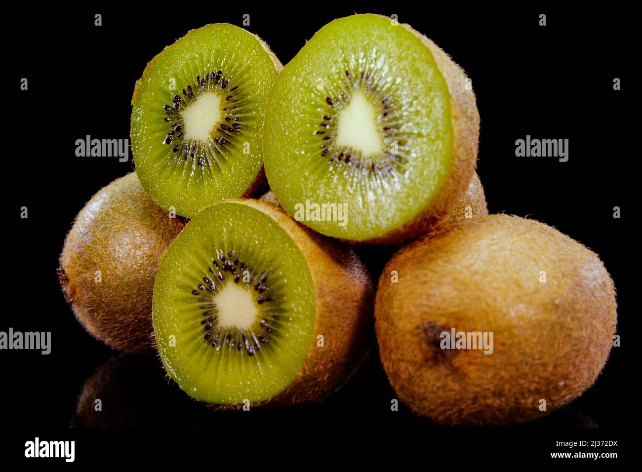 Kiwi fruit on a black background in. Close up of fresh and tasty kiwi, studio shot. Stock Photo