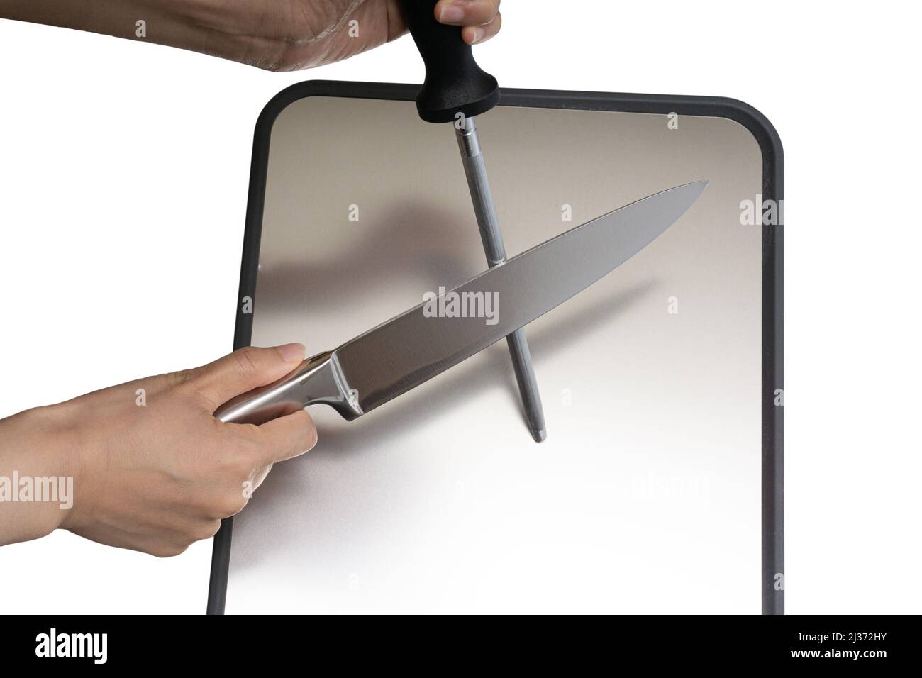 Various kitchen knives, scissors and cutting board Stock Photo