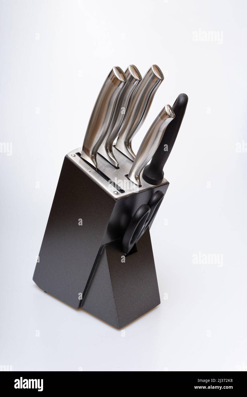 Various kitchen knives, scissors and cutting board Stock Photo
