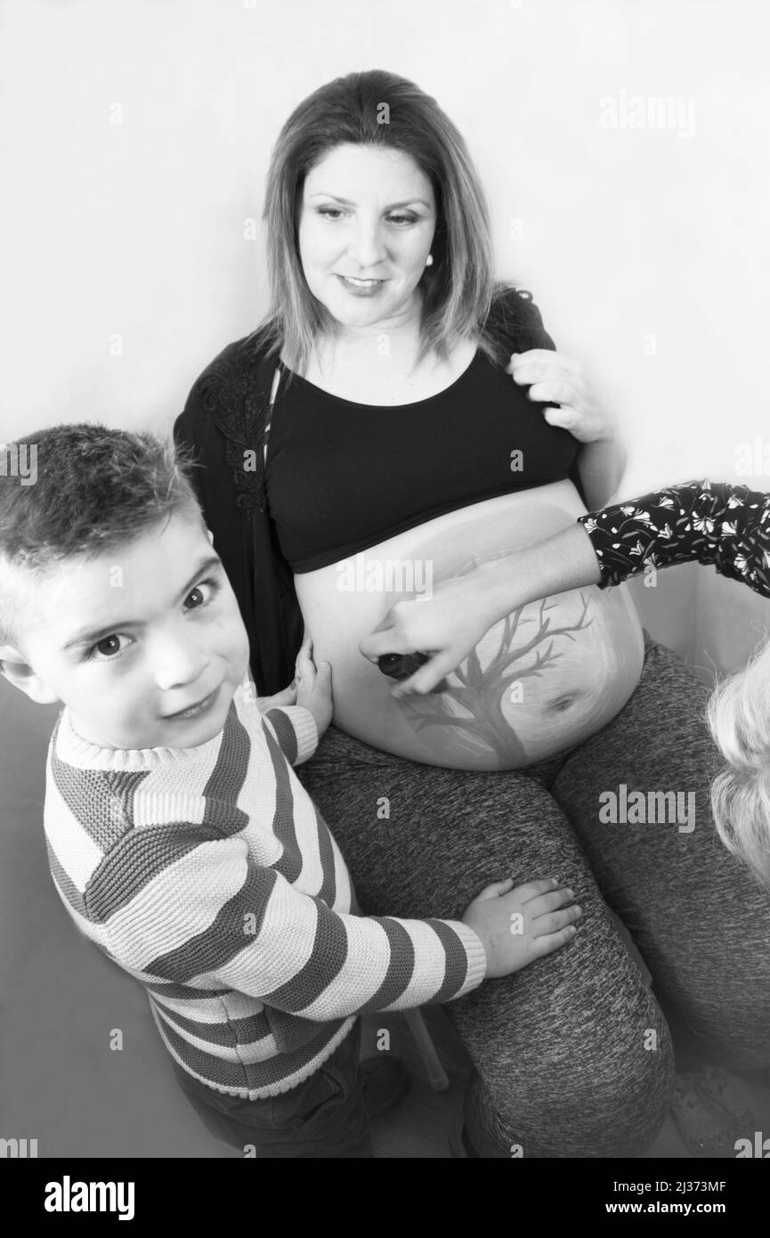 Eight month pregnant woman with three year old son. Body painting Stock Photo Alamy