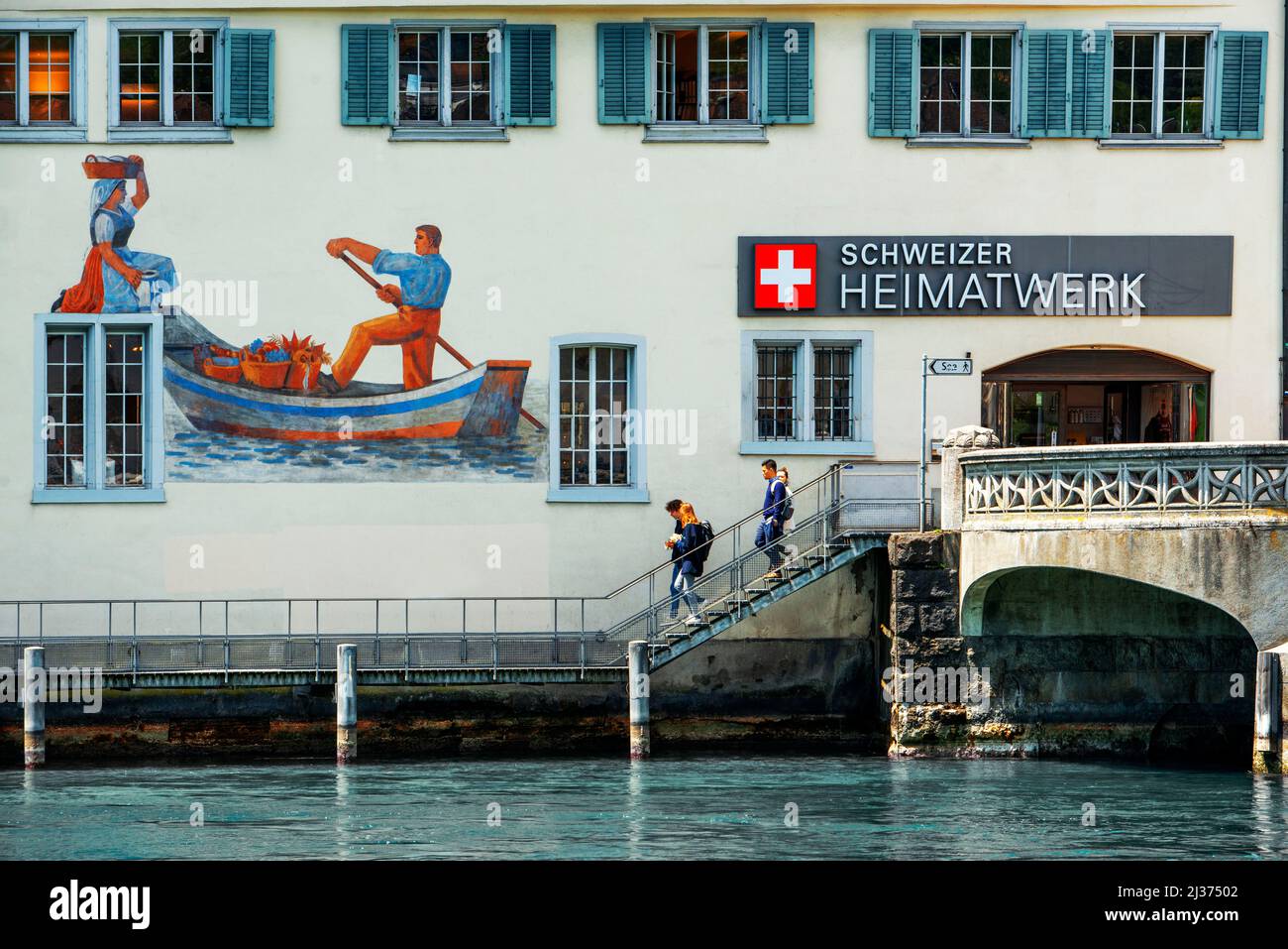 Zurich Swiss city on Limmat River and Lake painted mural on facade of Schweizer Heimatwerk building along river, Zurich Canton, Switzerland Stock Photo