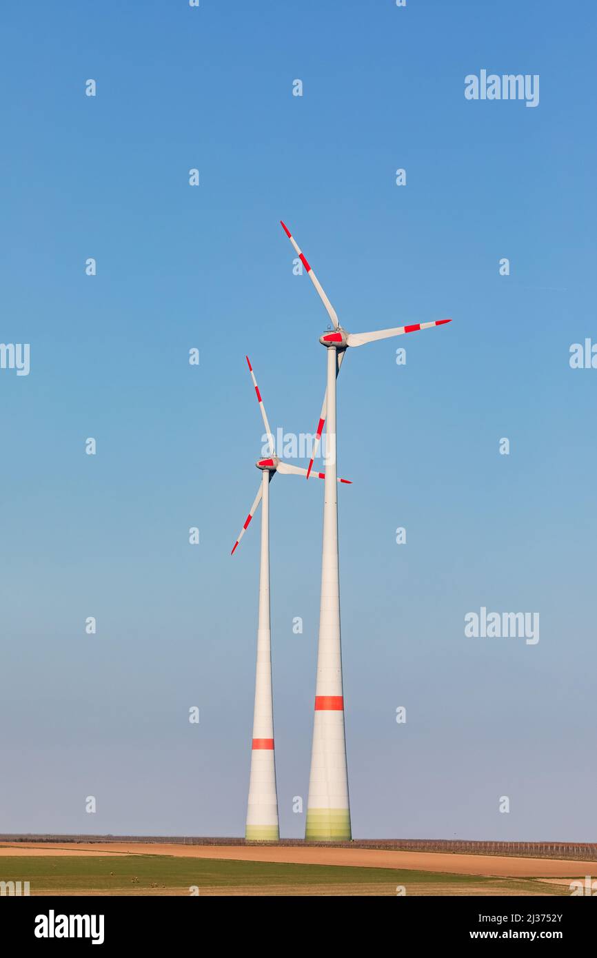 A rural field with wind turbines on a wind power plant is a necessary prerequisite for the German Energiewende Stock Photo