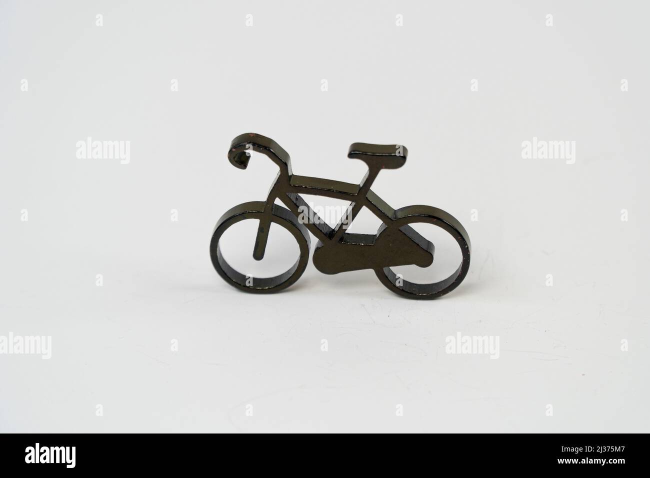 Bicycle toy object isolated on white background, black bike miniature bcycle icon key chain, solid metal color sembol front view Stock Photo