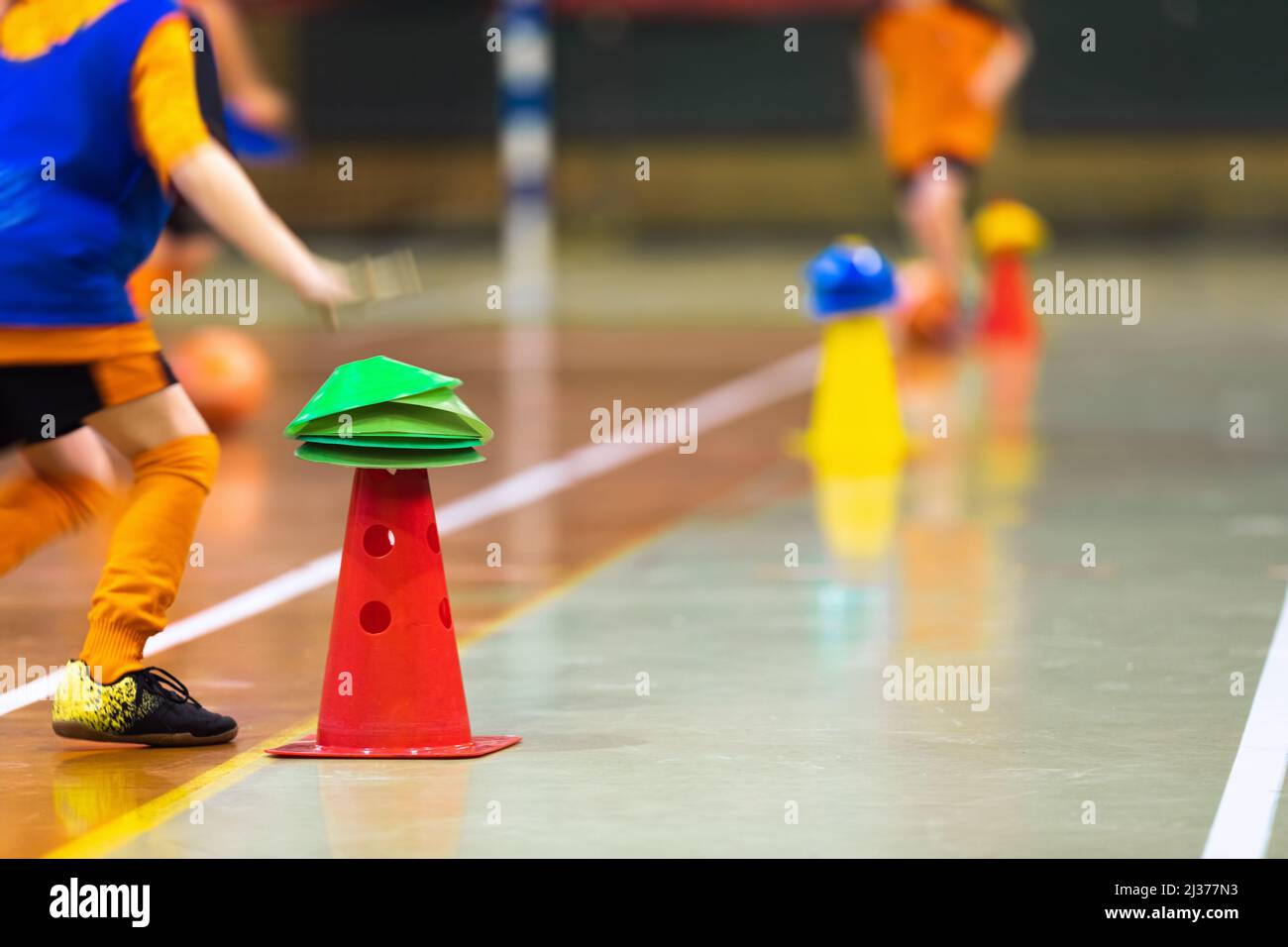 Happy children play indoor sports class. Kids running around training