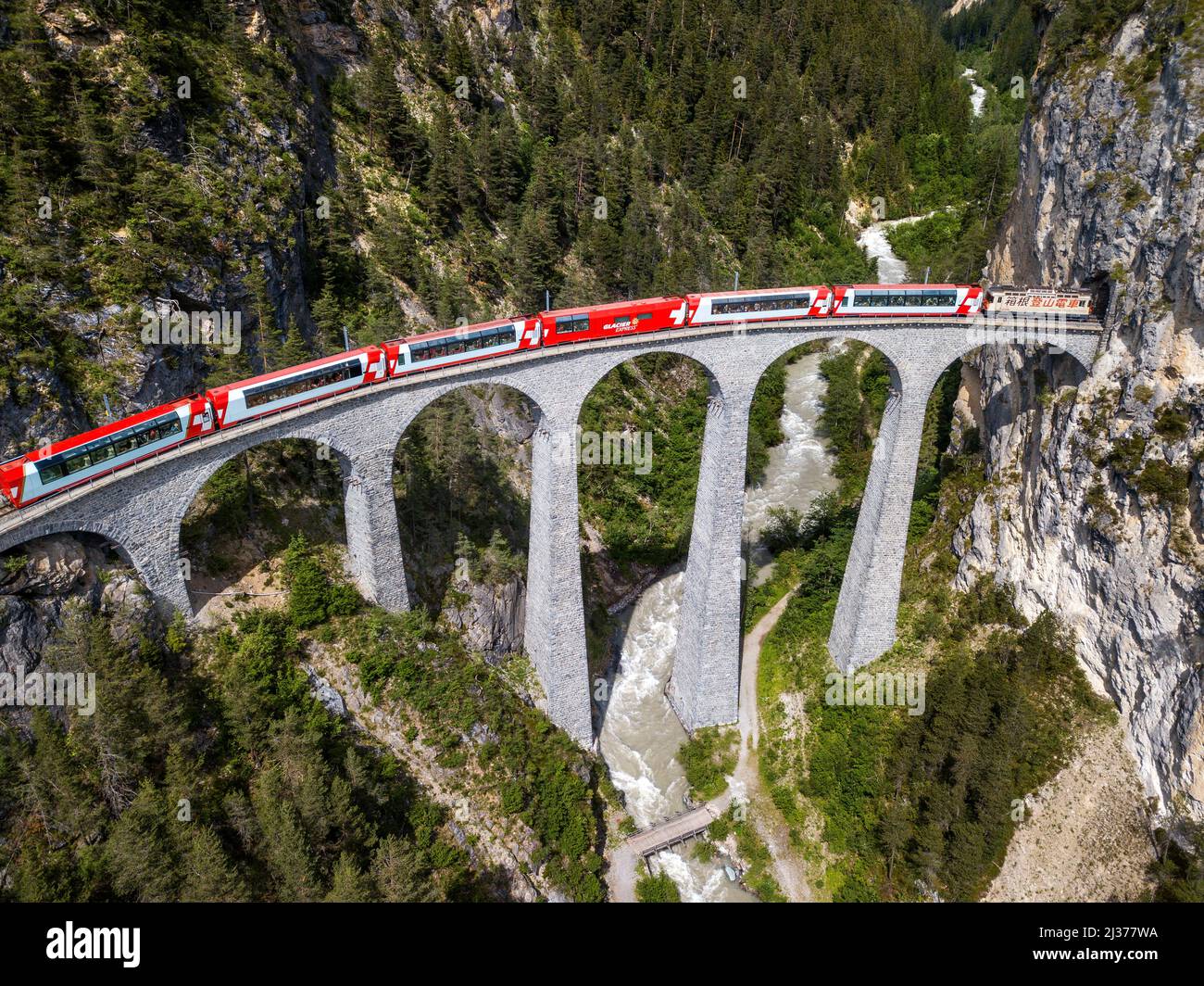 Glacier Express at the Landwasser Viaduct at Swiss Alps, Filisur, Graubunden Switzerland.  The Landwasser Viaduct is a single-track six-arched curved Stock Photo