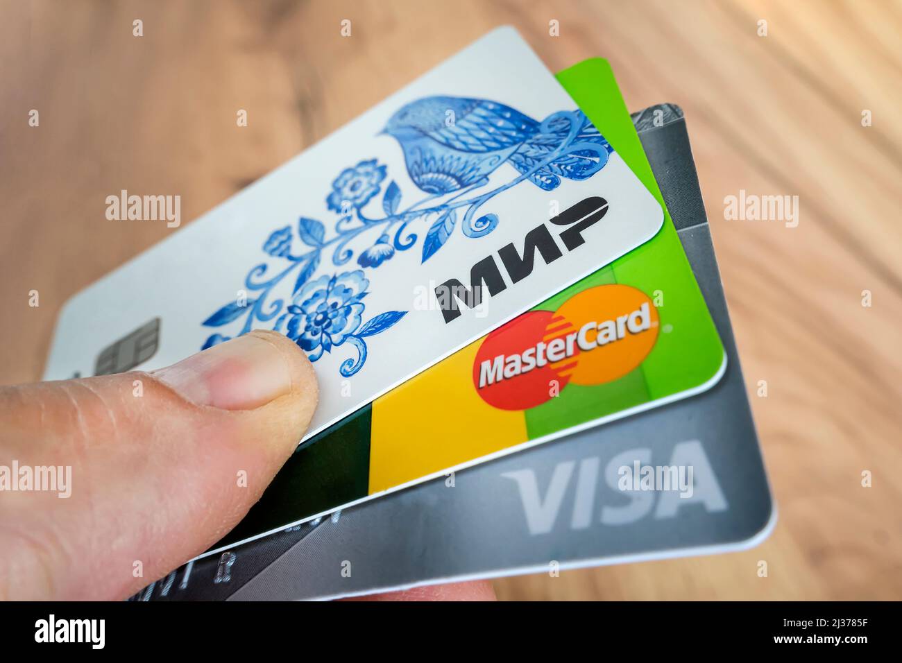 April 2, 2022. Barnaul. Russia: Bank cards with logos of three payment systems: Visa, Mastercard and Mir. Stock Photo