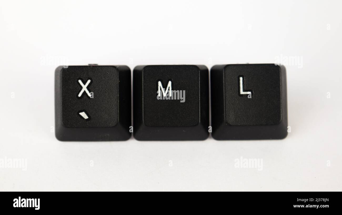 XML text created with keyboard keys isolated on white background, white xml on black keyboard, top view Stock Photo