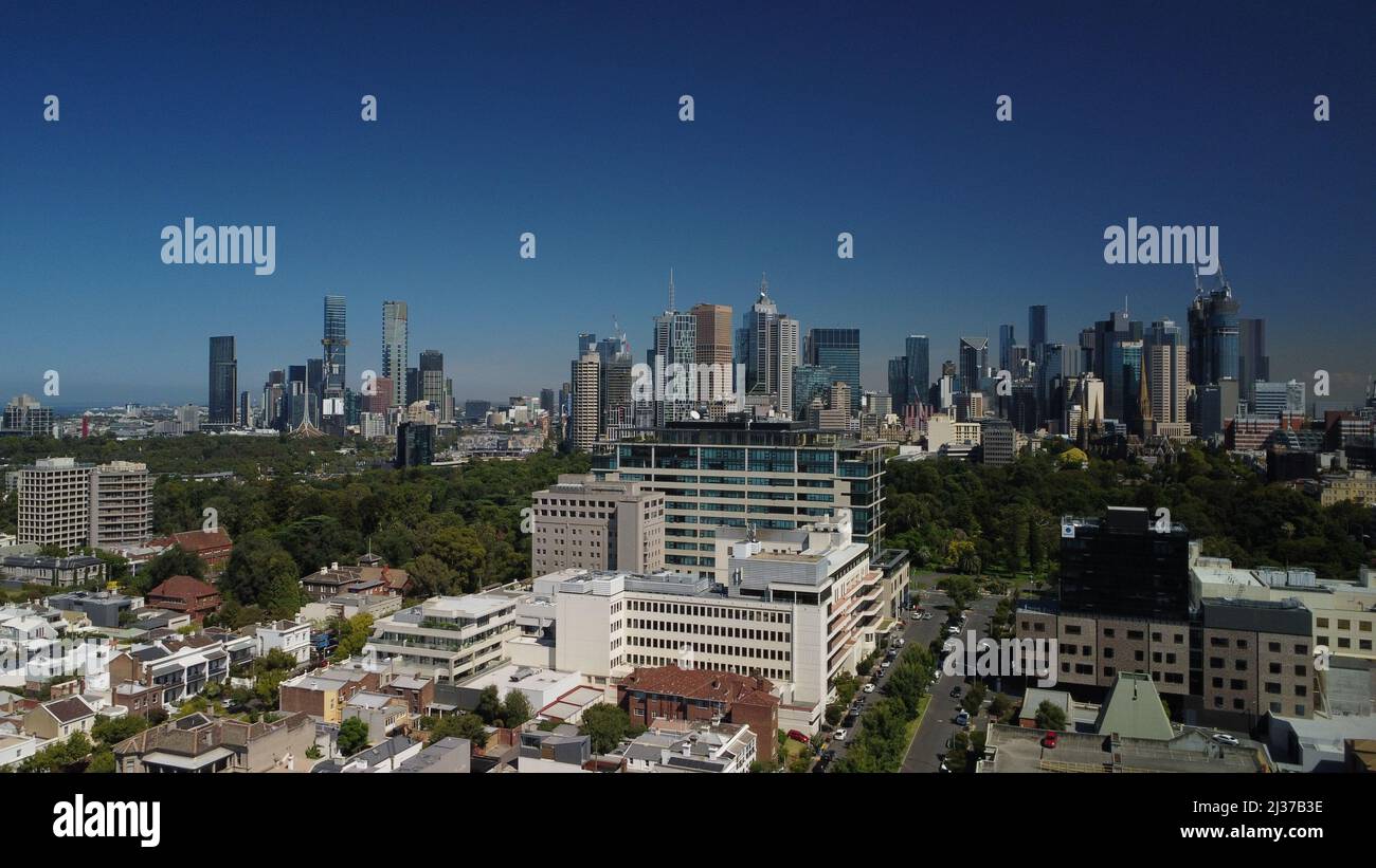 Aerial photo of East Melbourne hospital precinct and Fitzroy Gardens with Melbourne CBD in background Stock Photo