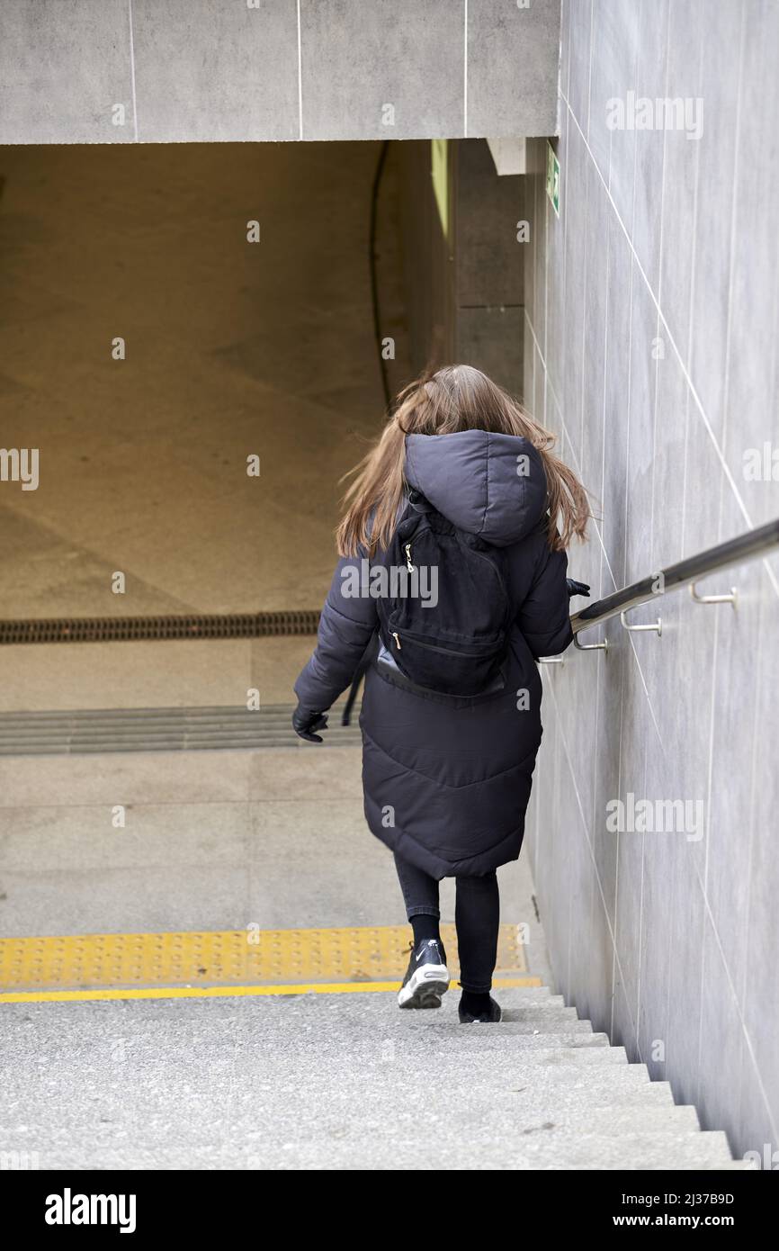 A woman walking down the stairs leading to the Kaponiera underground