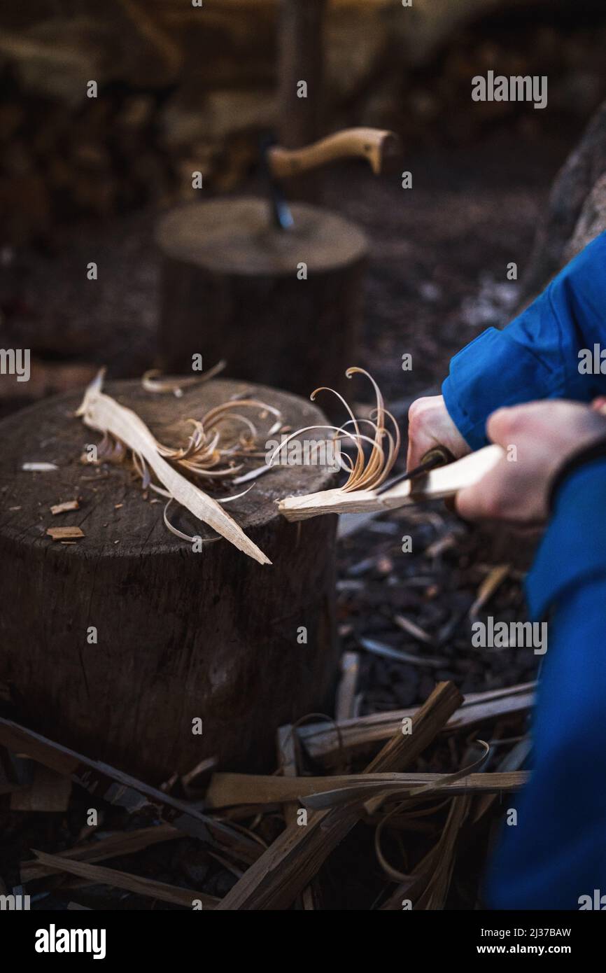 Carving curvy string from piece of wood Stock Photo - Alamy