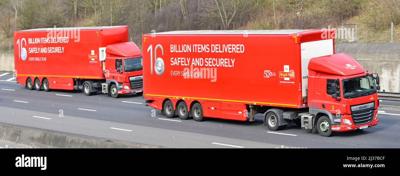 Side front view two of a kind duplicate red hgv Royal Mail DAF lorry truck & driver articulated trailer postal advertising driving on UK motorway road Stock Photo