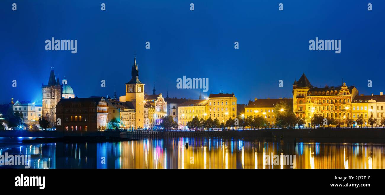Night panoramic view of Prague cityscape, Czech Republic. Old water tower. Reflection in Vltava River. Stock Photo