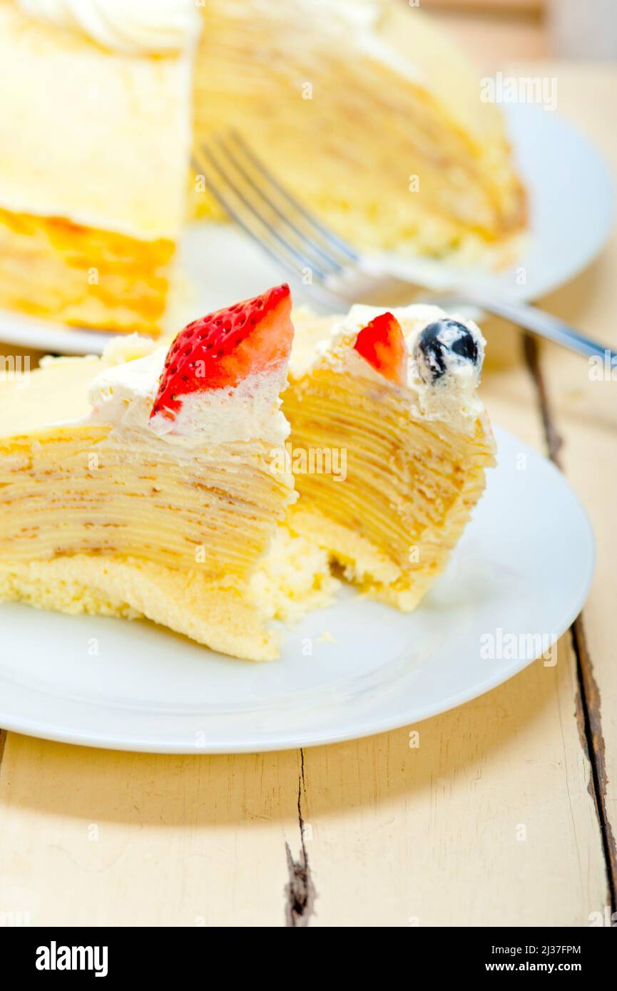 crepe pancake cake with whipped cream and strawberry on top Stock Photo